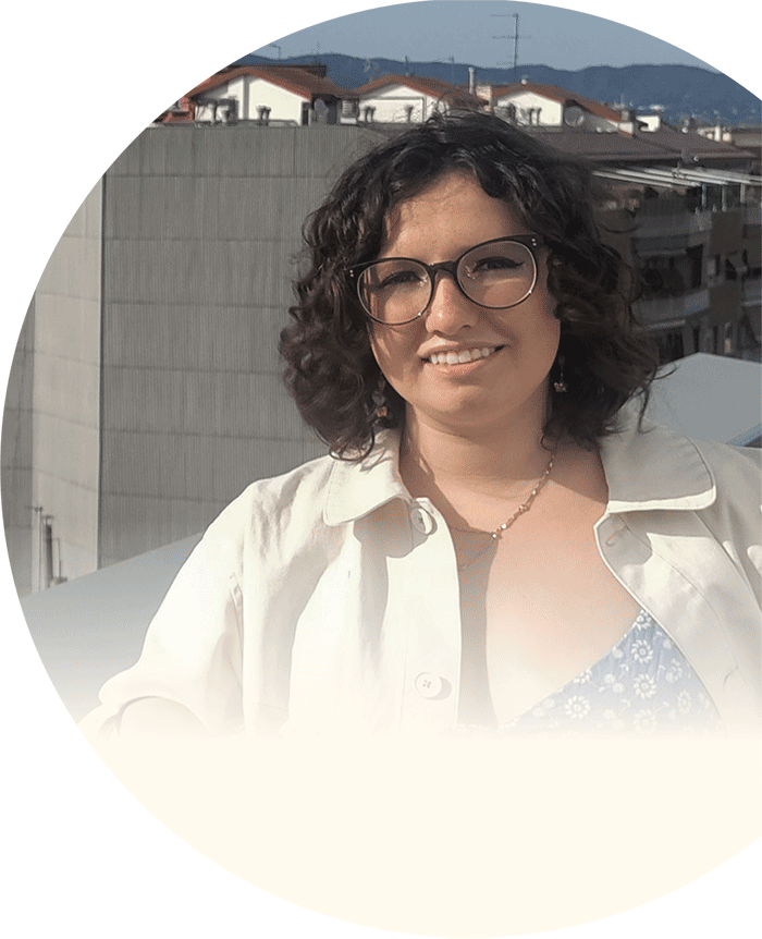 Olivia on a rooftop in Barcelona, blue dress white jacket