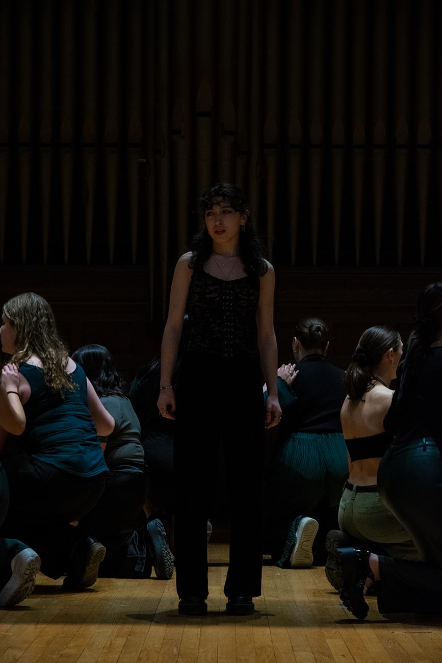 Soloist from Drexel University Treblemakers acapella group standing to sing while everyone else sits down